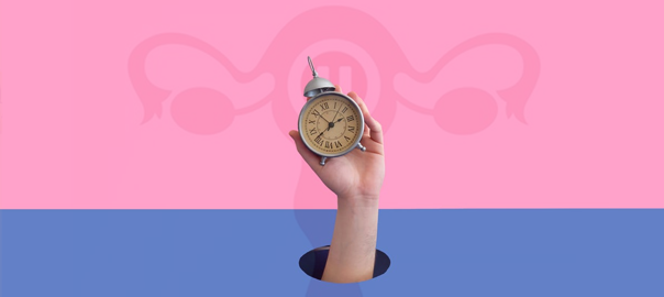 a hand holding a clock with a uterus in the background