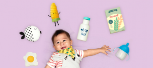 baby laying down with milk corn and cereal
