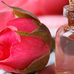 rosewater in a bottle with rose petals