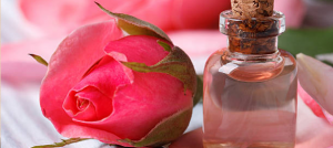 rosewater in a bottle with rose petals
