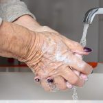 old woman washing hands