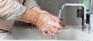old woman washing hands